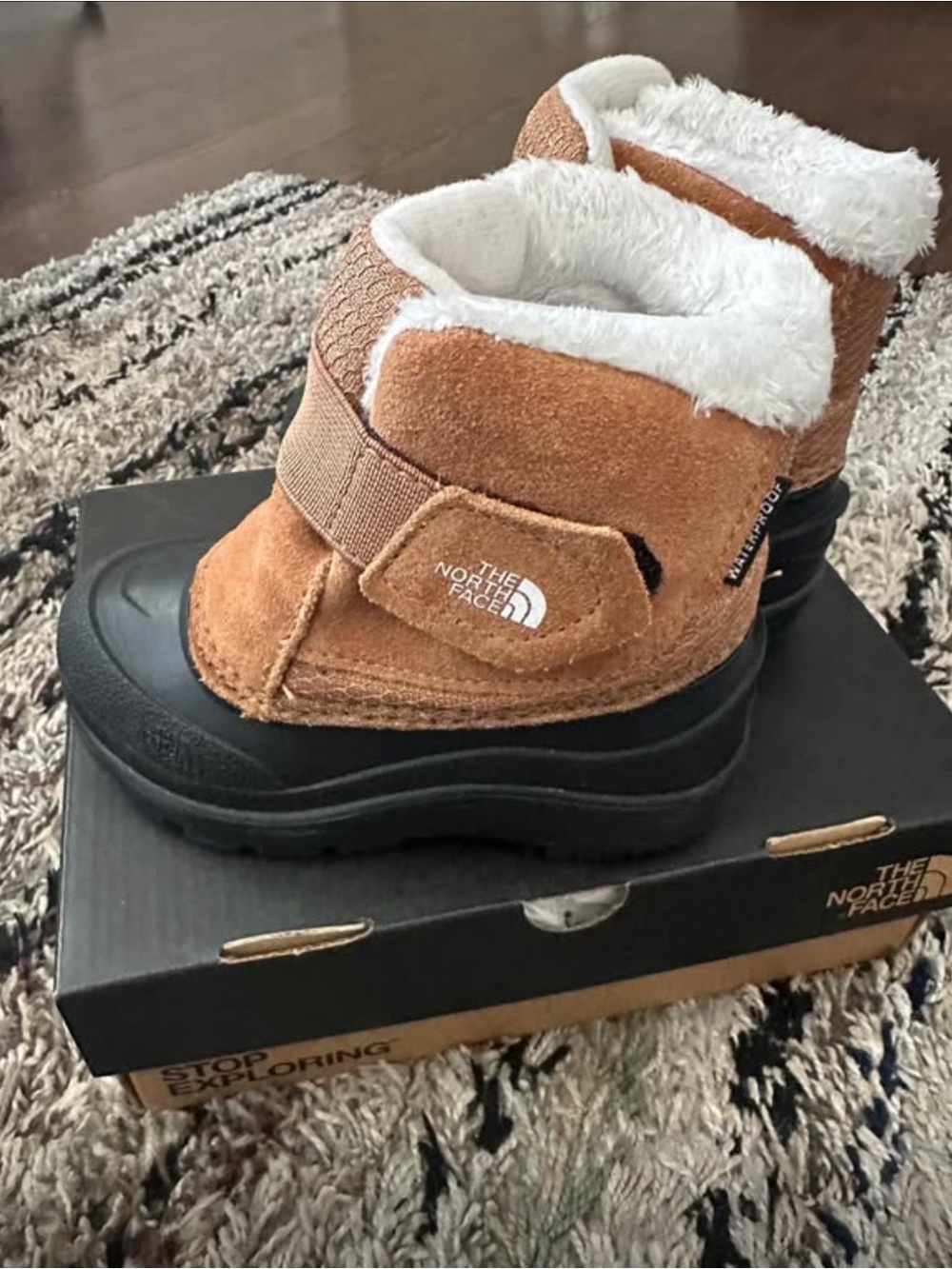 The North Face Kids Brown and Black Waterproof Snow Boots with White Fleece.